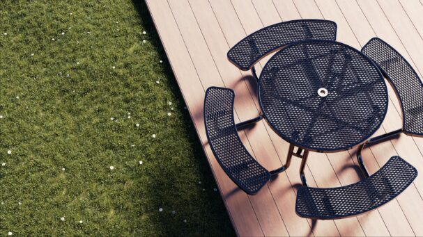 Round black picnic table sitting on a wooden patio