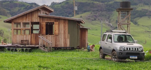 Finished tiny cabin built off-grid in a remote rural area with surrounding hills