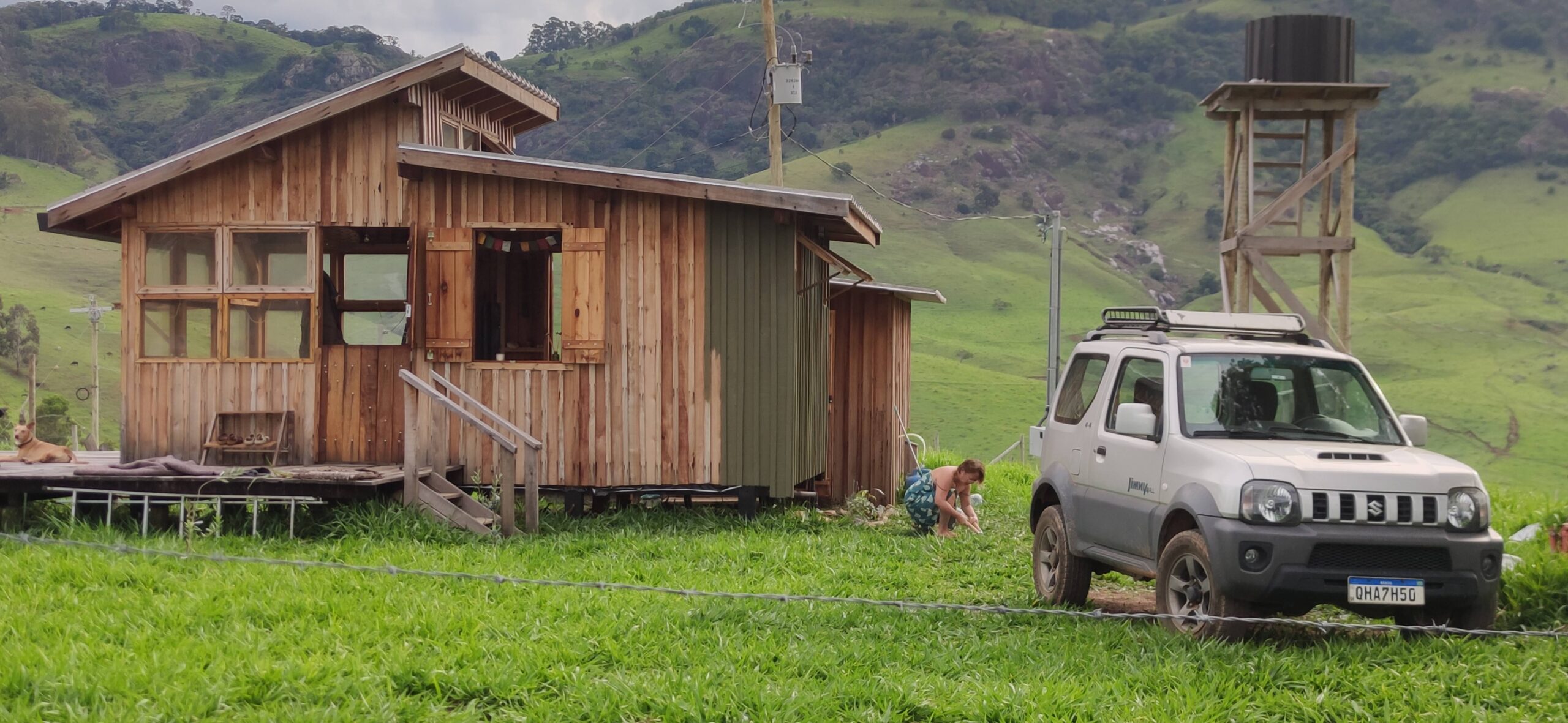 Finished tiny cabin built off-grid in a remote rural area with surrounding hills