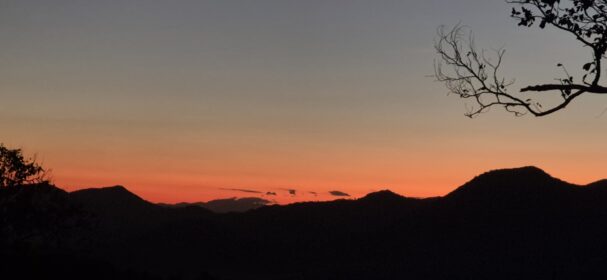 Sunset mountain view from remote off-grid tiny cabin