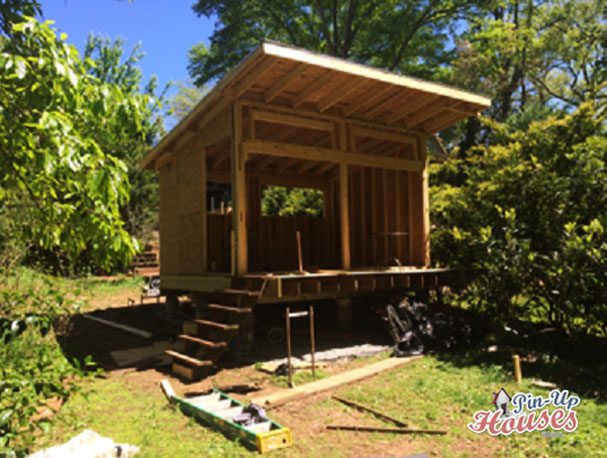 timber frame of cabin with OSB boards cladding