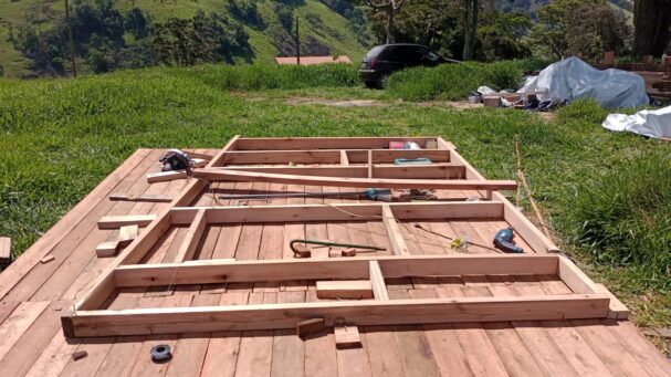 DIY tiny house floor frame under construction using wooden beams