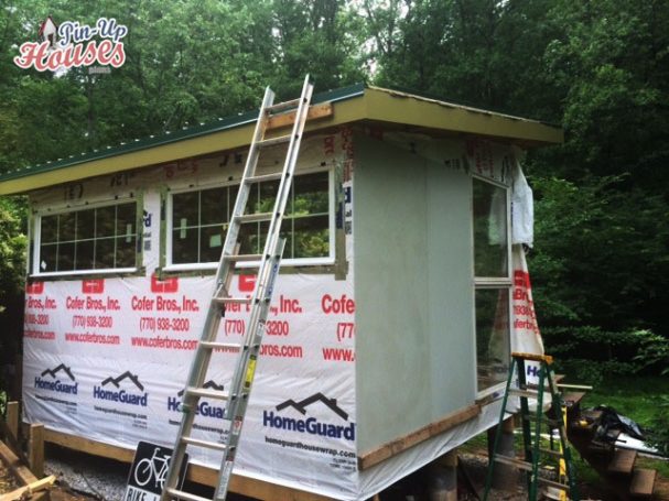 wall cladding of DIY wood cabin, metal roof sheeting